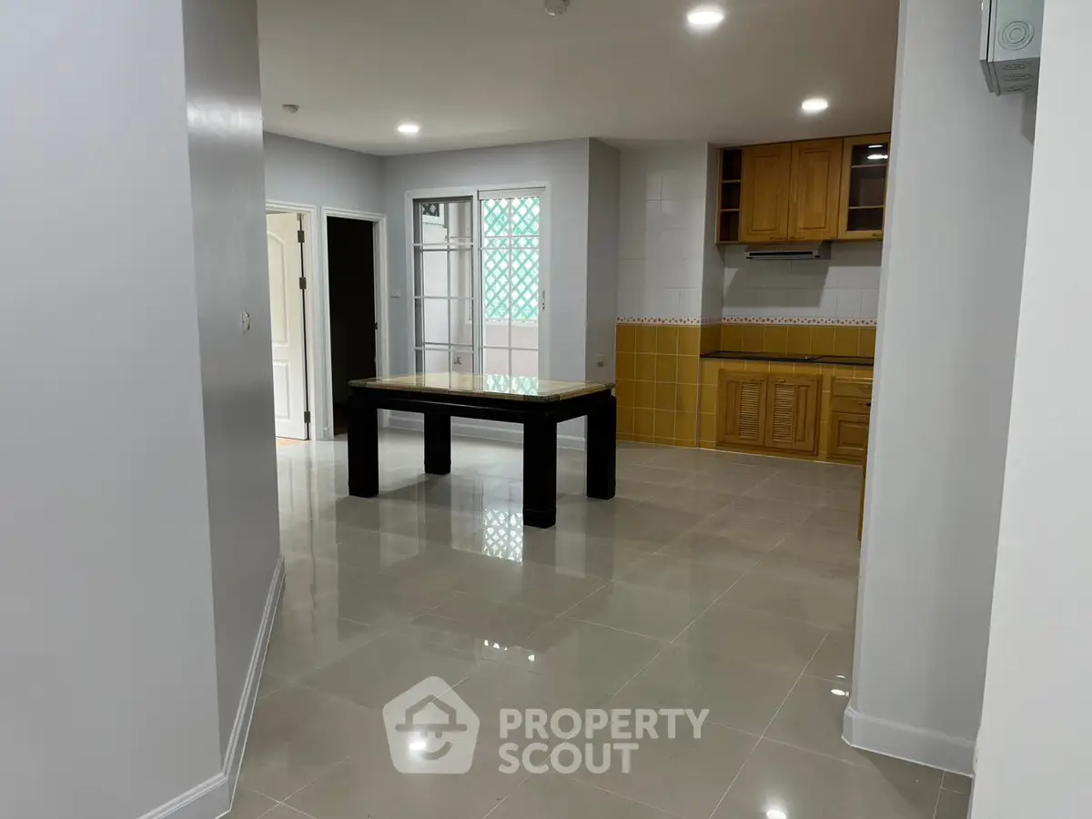 Spacious open-plan kitchen and dining area with modern finishes and ample natural light.
