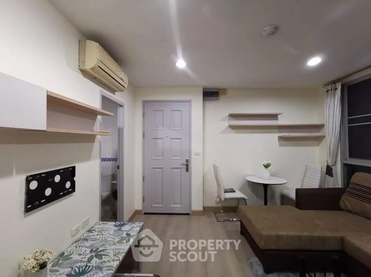 Cozy living room with modern decor and air conditioning in a stylish apartment.