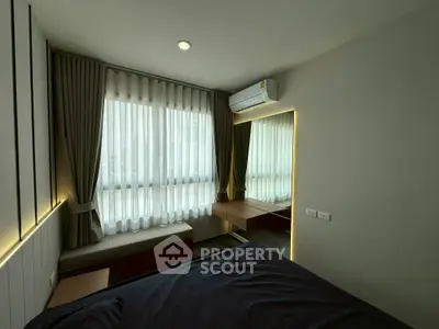 Modern bedroom with large window, stylish curtains, and sleek air conditioning unit.