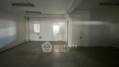Spacious empty room with potential for customization in a real estate property.