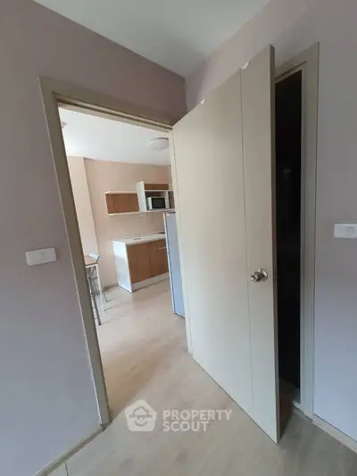 Modern apartment interior with open kitchen and light wood flooring