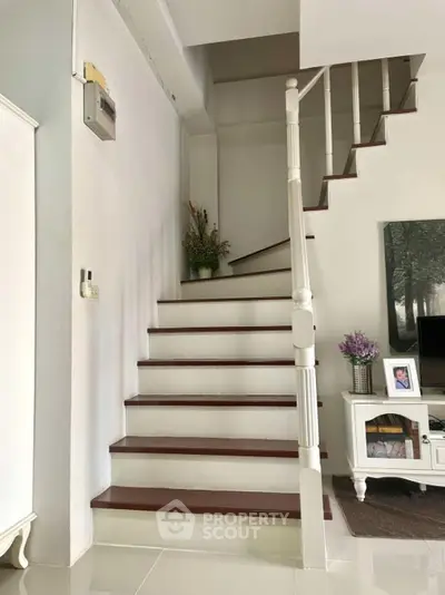 Elegant staircase in modern home with stylish decor and natural light