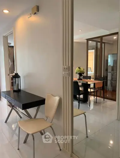 Modern apartment interior with sleek dining area and stylish furniture, showcasing contemporary design and elegance.