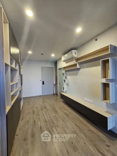 Modern living room with sleek built-in shelves and wood flooring