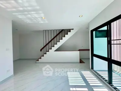 Modern minimalist interior with sleek staircase and large windows