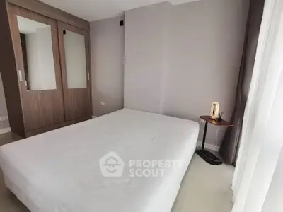 Spacious bedroom with modern wardrobe and natural light