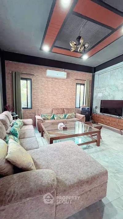 Spacious living room with modern decor and large sectional sofa, perfect for family gatherings.