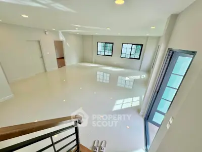 Spacious modern living room with large windows and glossy tile flooring