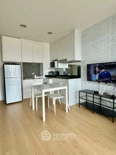 Modern kitchen and dining area with sleek design and natural light