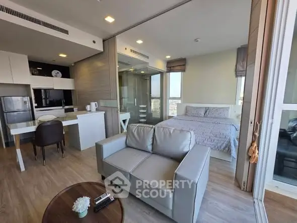 Modern studio apartment with open layout, featuring a cozy living area, compact kitchen, and comfortable bedroom.