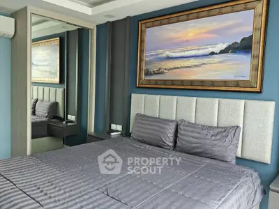 Modern bedroom with stylish decor and large mirror reflecting ocean-themed artwork.