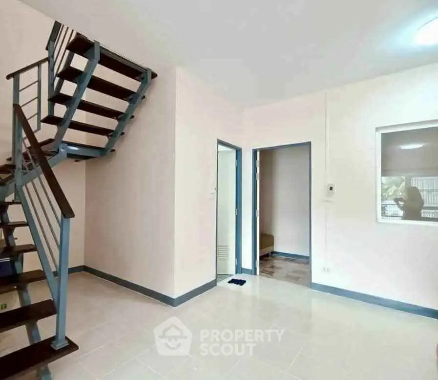 Modern interior with sleek staircase and open layout, perfect for contemporary living.