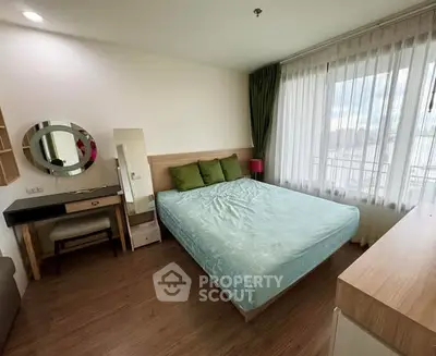 Cozy bedroom with large window and modern furnishings