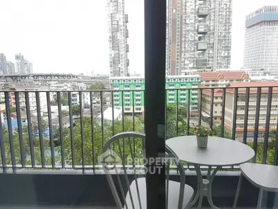 Modern balcony with city view, featuring a cozy seating area perfect for relaxation and enjoying the urban skyline.