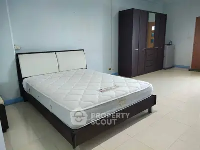 Spacious bedroom with modern furniture and ample storage space