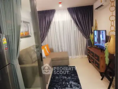 Cozy living room with modern decor, plush sofa, and flat-screen TV, perfect for relaxation.