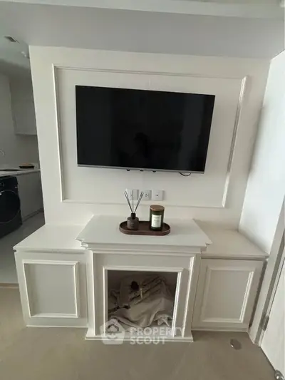 Modern living room with wall-mounted TV and elegant cabinetry, showcasing stylish interior design.