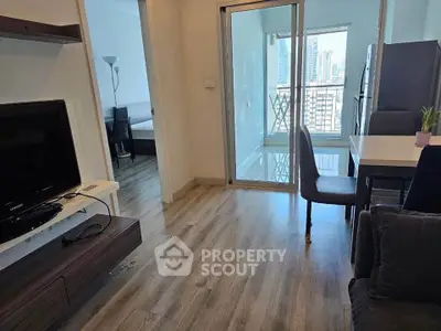 Modern apartment with open living area and city view balcony, featuring sleek furniture and stylish flooring.