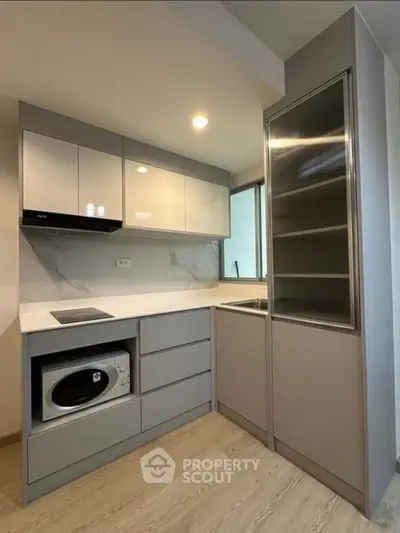 Modern kitchen with sleek cabinetry and built-in appliances in a compact layout.