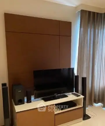 Modern living room with sleek entertainment setup and elegant curtains