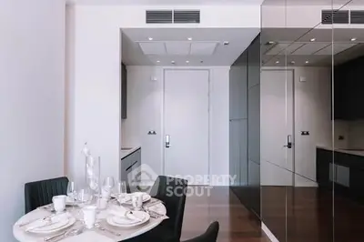 Modern dining area with sleek kitchen design and elegant table setting.