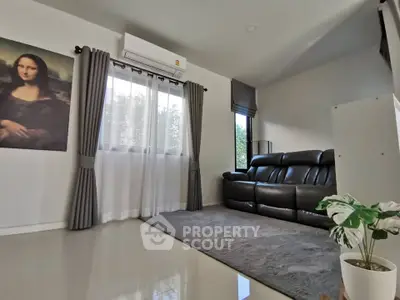 Spacious living room with modern decor and large windows for natural light.