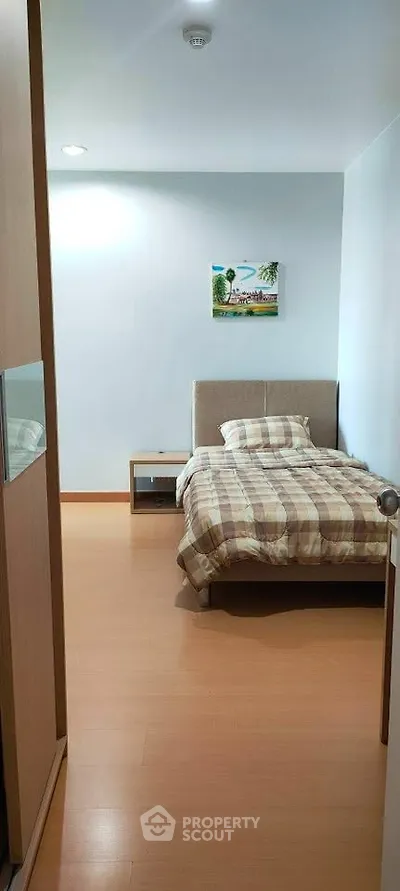 Cozy bedroom with modern decor and wooden flooring