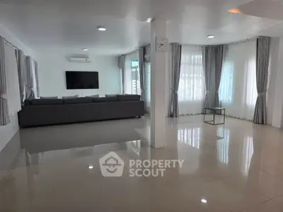 Spacious modern living room with sleek design and ample natural light