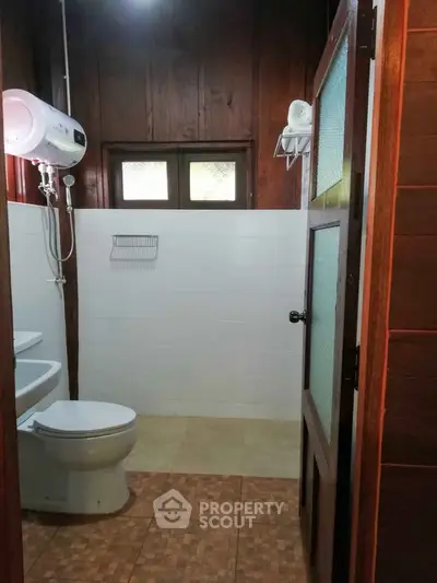 Charming rustic bathroom with wooden accents and modern amenities in cozy home.
