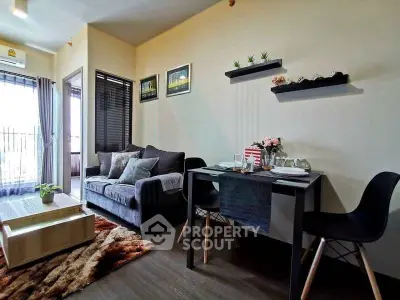 Modern living room with cozy sofa, dining area, and balcony access in stylish apartment.