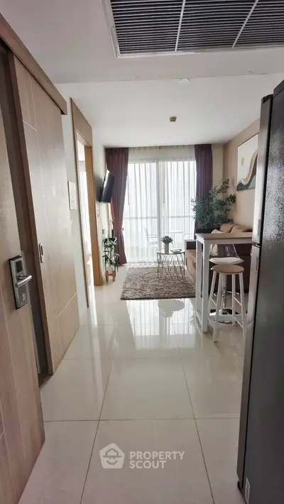 Modern living room with open layout and stylish decor, featuring a cozy seating area and natural light.