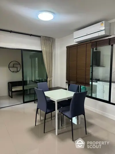 Modern dining area with sleek table and chairs, adjacent to a cozy study nook.