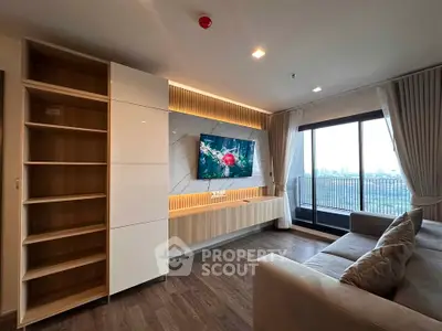 Modern living room with sleek built-in shelving and large balcony offering stunning city views.
