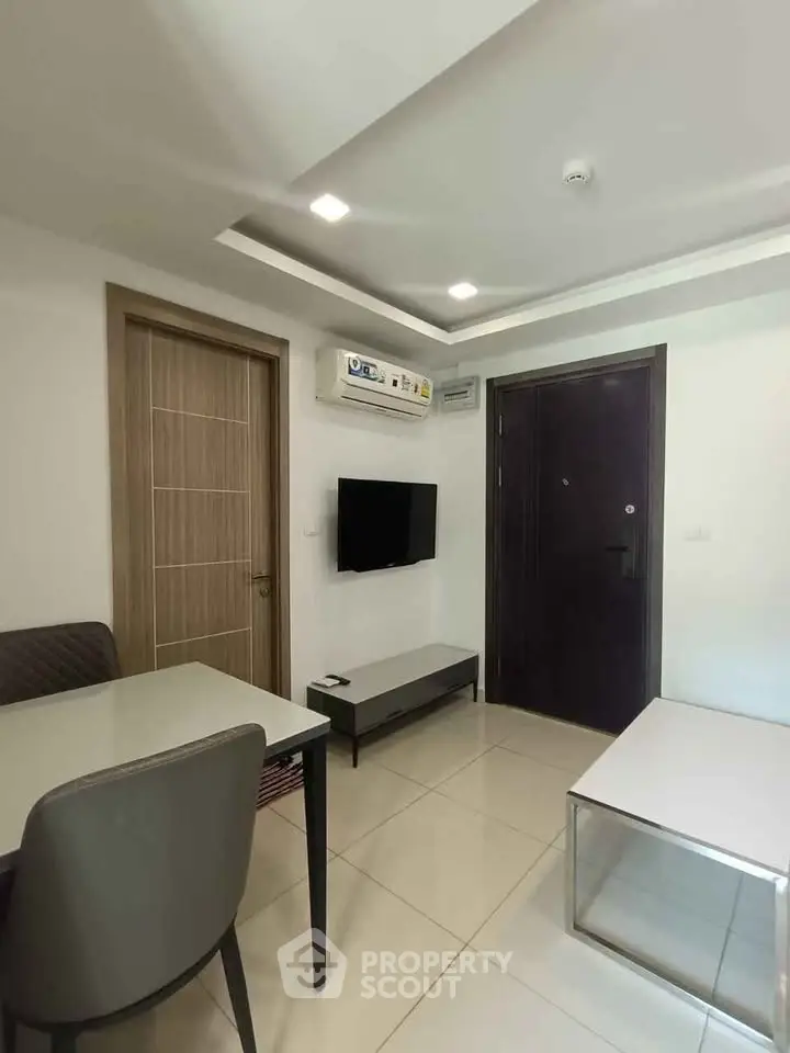 Modern living room with sleek furniture and air conditioning in a contemporary apartment.