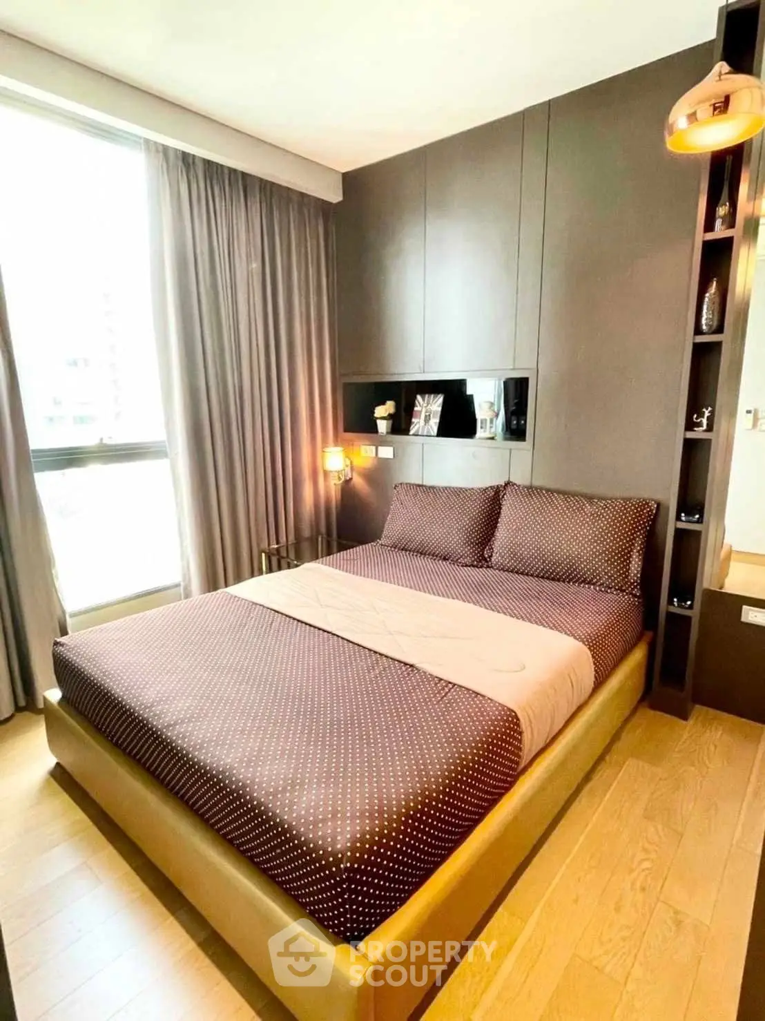 Modern bedroom with stylish decor and large window for natural light