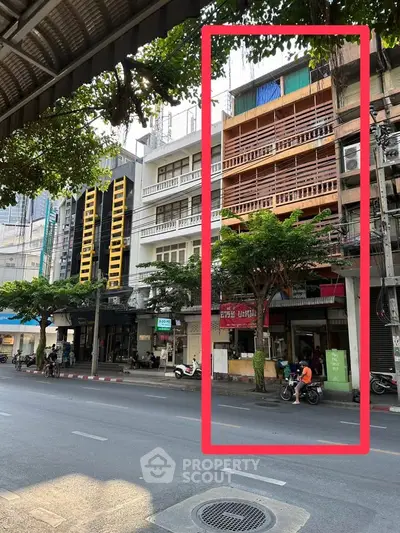 Urban street view with multi-story buildings and vibrant city life.