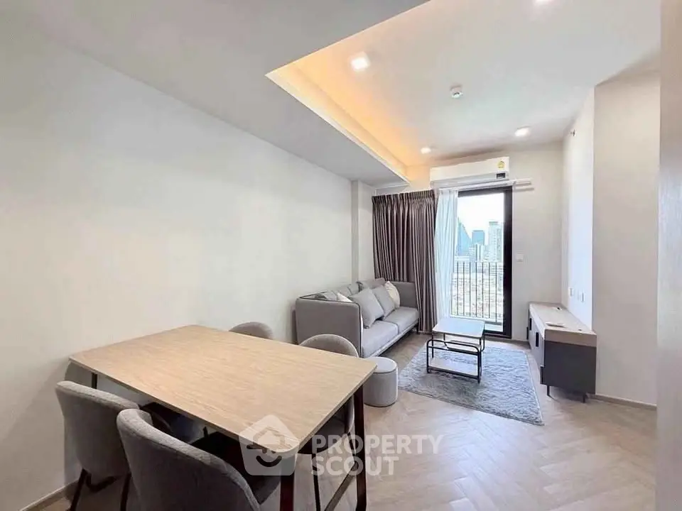 Modern living room with dining area and balcony view in a stylish apartment.