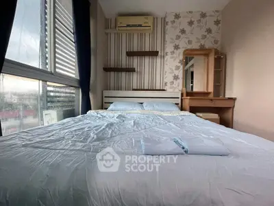 Cozy bedroom with modern decor and large window for natural light