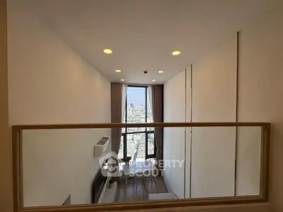 Modern high-rise apartment with stunning city view and stylish interior design.