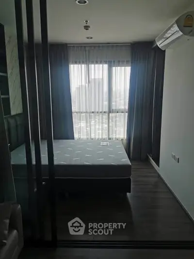 Modern bedroom with large window and air conditioning unit