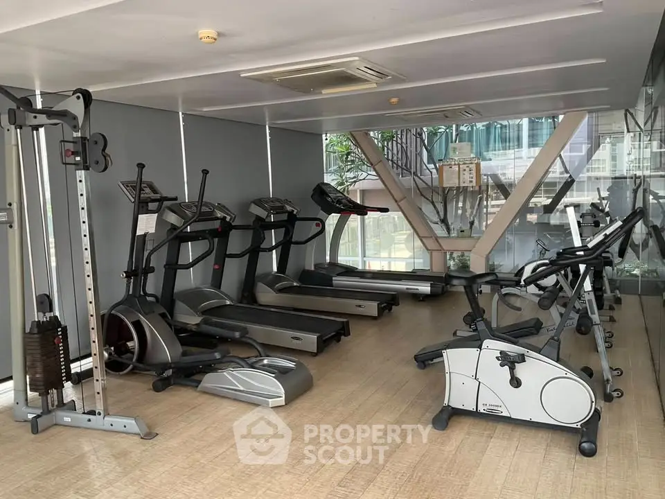 Modern gym with state-of-the-art equipment in a sleek residential building.
