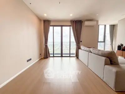 Spacious living room with panoramic city view and modern furnishings