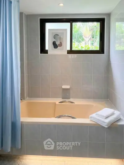Luxurious bathroom with elegant bathtub and serene window view