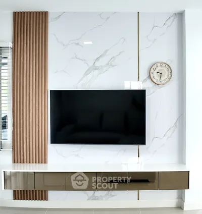 Modern living room with sleek wall-mounted TV and stylish marble accent wall