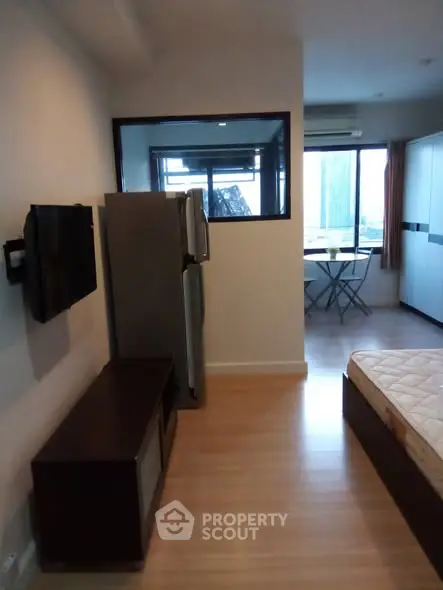 Modern studio apartment with wooden flooring and city view