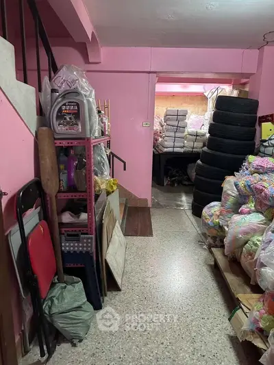 Spacious storage area with organized shelves and stacked tires, ideal for business or personal use.