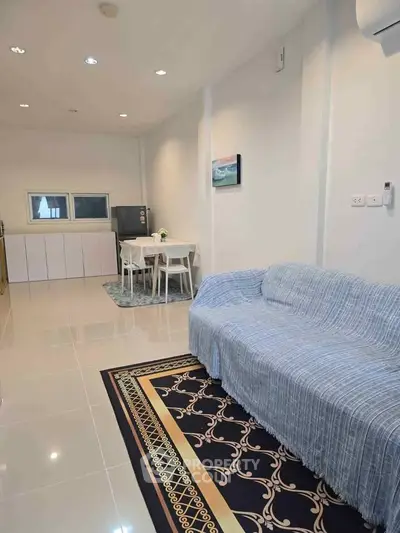 Spacious living room with modern decor and dining area in open layout.