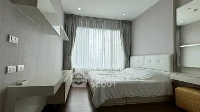 Modern minimalist bedroom with large window and sleek furnishings