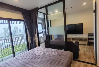 Modern bedroom with city view and balcony access in high-rise apartment