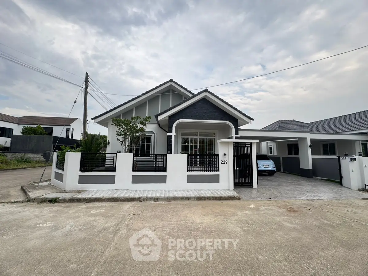 Charming modern house with a sleek exterior and spacious driveway in a serene neighborhood.